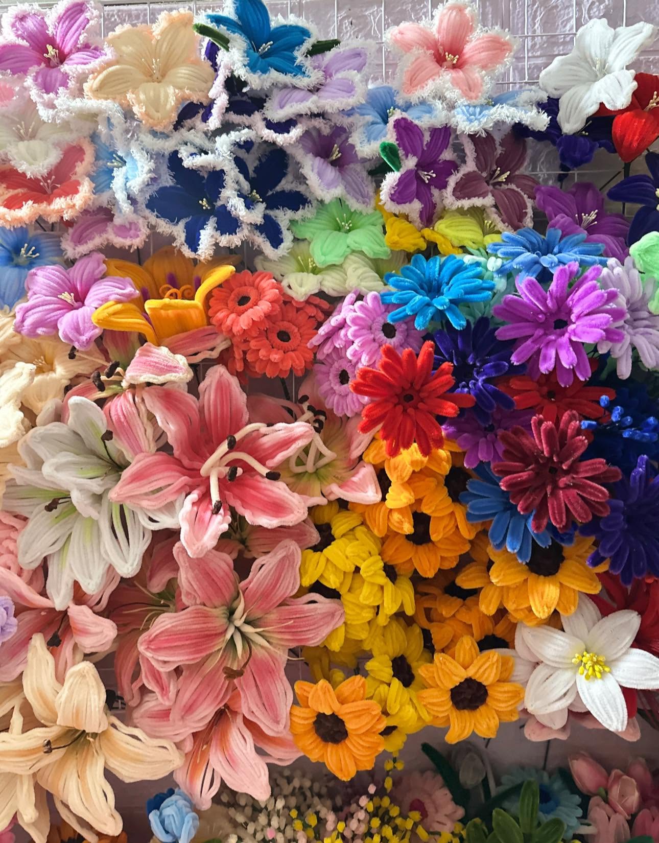 Close-up of handmade fuzzy wire chenille flowers